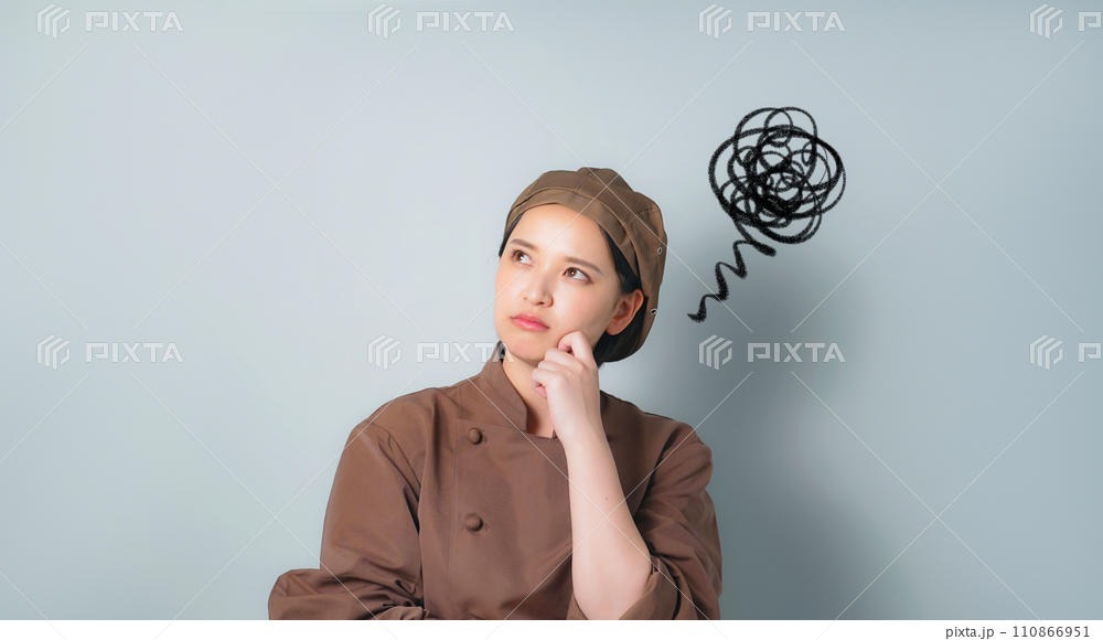 上をむいて悩む飲食店店員